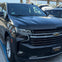 A black Chevrolet SUV parked in a lot, with "Rivas Enterprises LLC" on the front license plate holder.