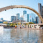 Nathan Phillips Square in Toronto featuring a fountain, the "Toronto" sign, and modern buildings under a clear sky.