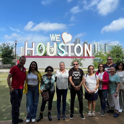 Guests are enjoying a photo in front of the We Love Houston sign during the Astroville Best of Houston City Tour.