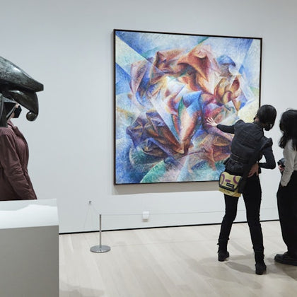 Three people observe an abstract painting in a museum gallery, with a sculpture visible on the left in the foreground.