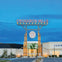 CrossIron Mills shopping center entrance with a large sign and surrounding shops, including Tommy Hilfiger under a twilight sky.