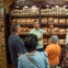 This image captures the fascinating process of crafting authentic Cuban cigars at a local cigar factory in Little Havana