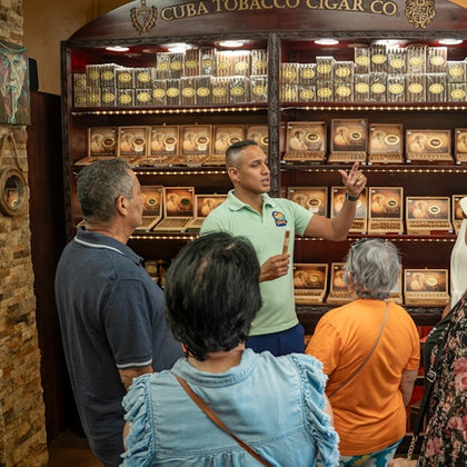 This image captures the fascinating process of crafting authentic Cuban cigars at a local cigar factory in Little Havana